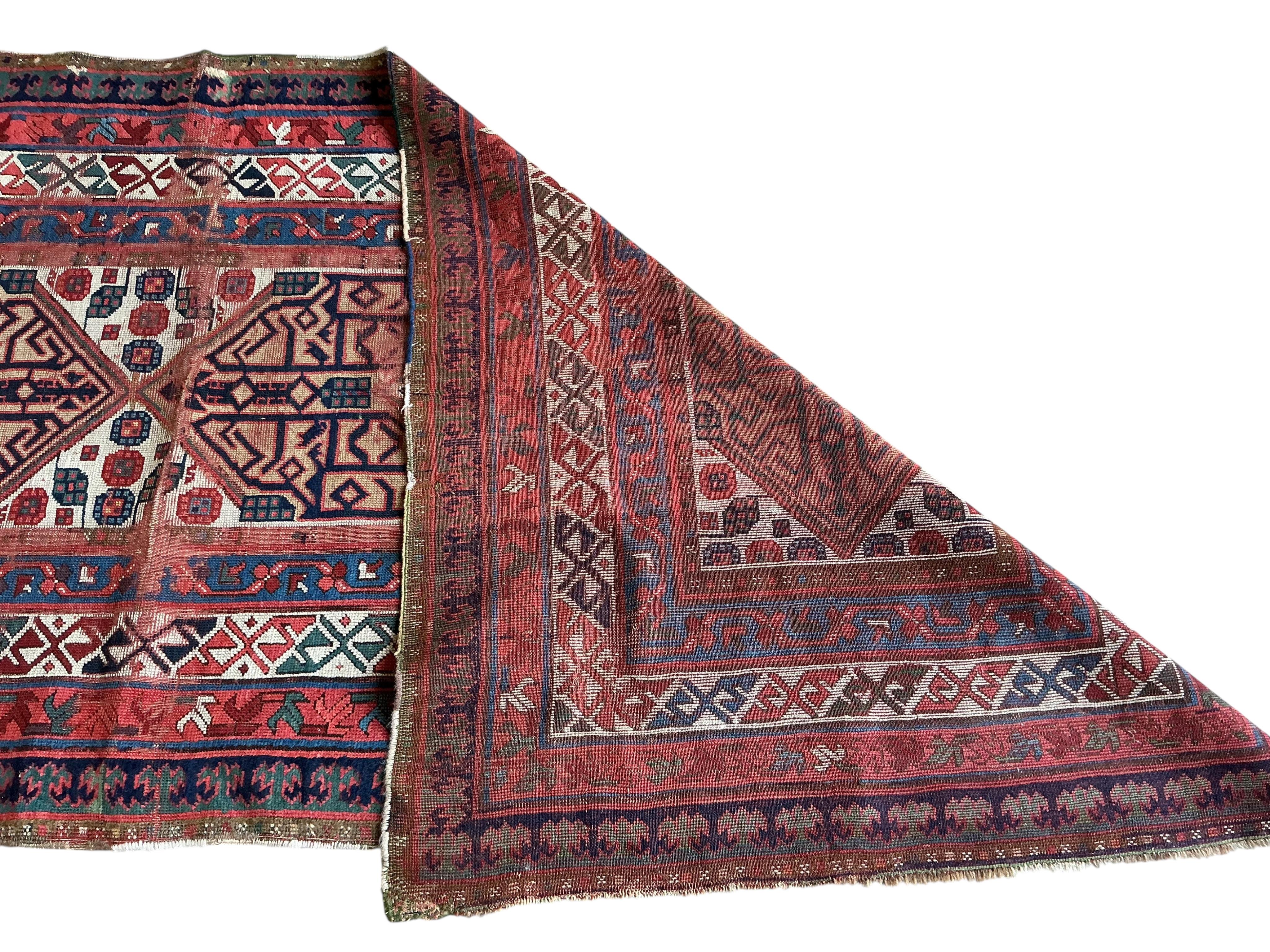An antique Caucasian red ground runner, 260 x 102cm